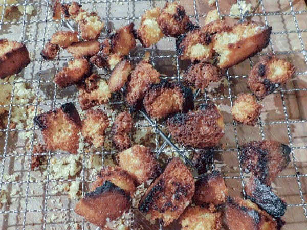 Cornbread croutons cooked, on a rack.