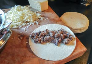 Beef & Bean Burritos pre-rolling on chopping block