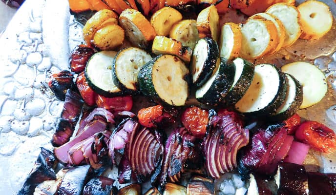 Closeup of grilled Rainbow Veggie Skewers on silver platter