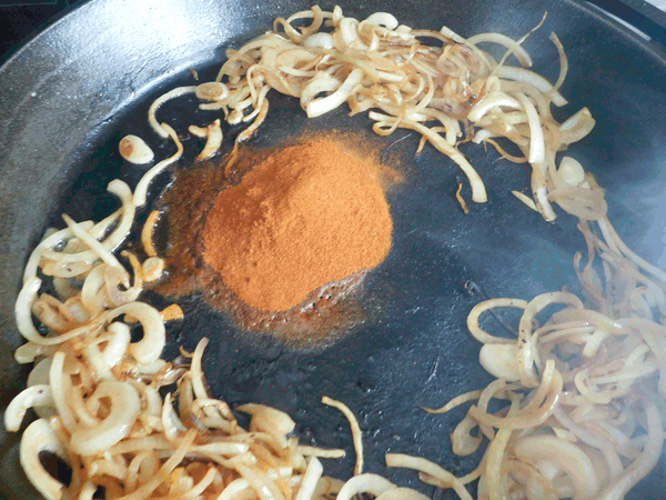 sauteeing onions and paprika in cast iron skillet