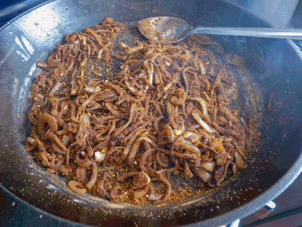 Onions and paprika sauteing in cast iron pot