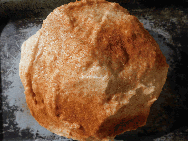 Head of cauliflower covered with mayo dressing and paprika