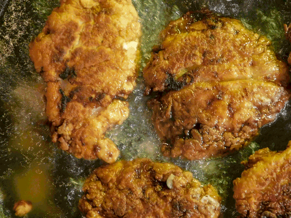 Brown and Crispy Chicken ready to be taken out of the fryer
