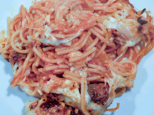 Gooey cheesy spaghetti with sauce and meatballs