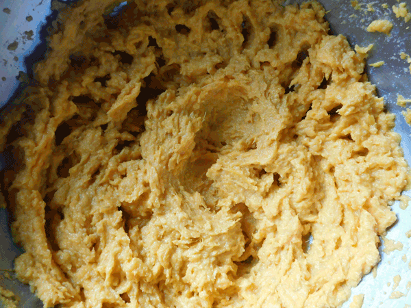 Mashed whipped sweet potatoes in a silver mixing bowl