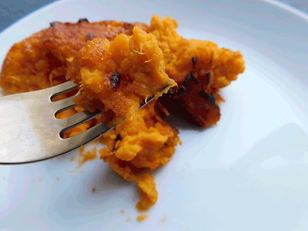 Close up of Mashed and baked sweet potatoes on a fork