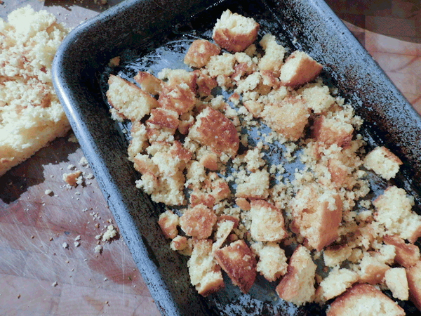 Pre-baking cornbread croutons ona bakind dish