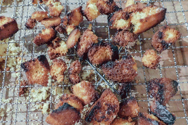 Cornbread croutons cooked, on a rack.