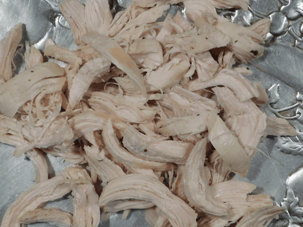 Shredded chicken on a silver platter