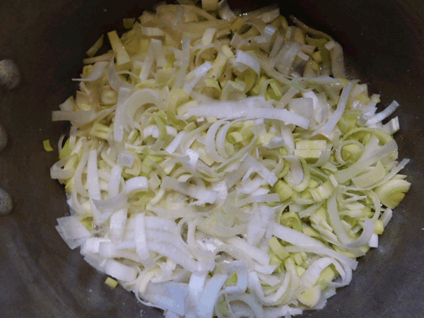 sliced leeks in a soup pot
