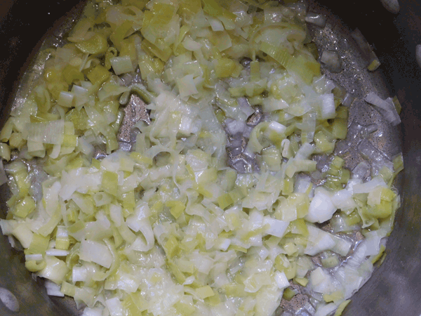 Cooked leeks and butter in a soup pot