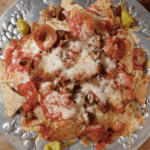 cooked pizza nachos on silver platter