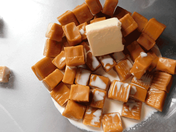 unwrapped caramels in glass bowl with creamand butter