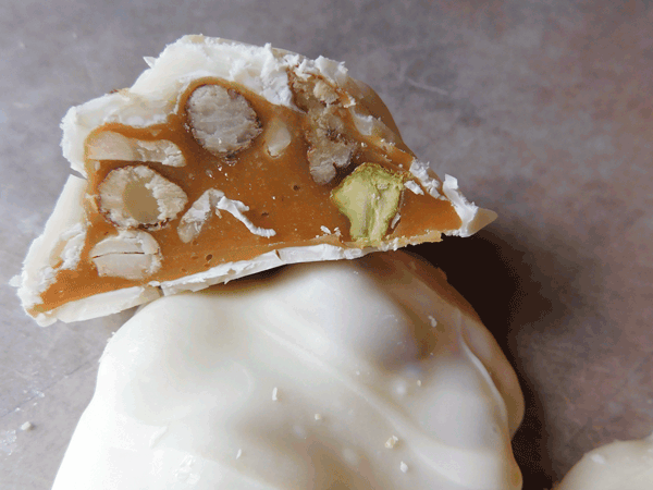 Cross section showing caramel and nuts inside white chocolate