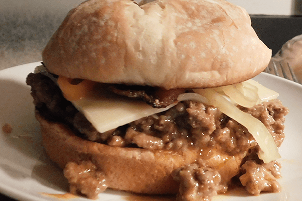 Sloppy Joe on a toasted bun on a white plate