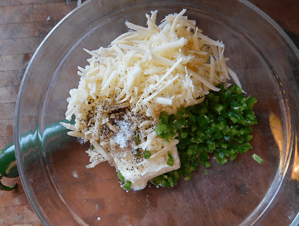 Cream cheese, cheddar cheese jalapenos in glass bowl