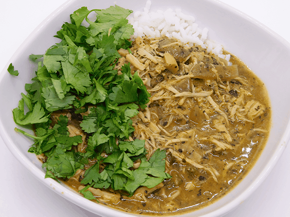 White bowl with chicken and cilantro over rice