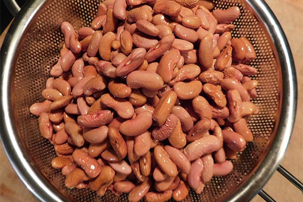 Soaked red beans in a colander