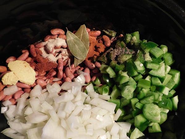 Soaked red beans with green peppers, onions and spices in a crock pot