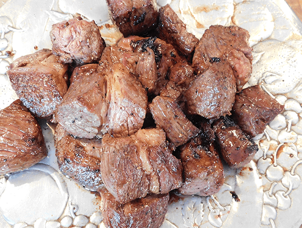 Seared beef chuck cubes on a silver platter