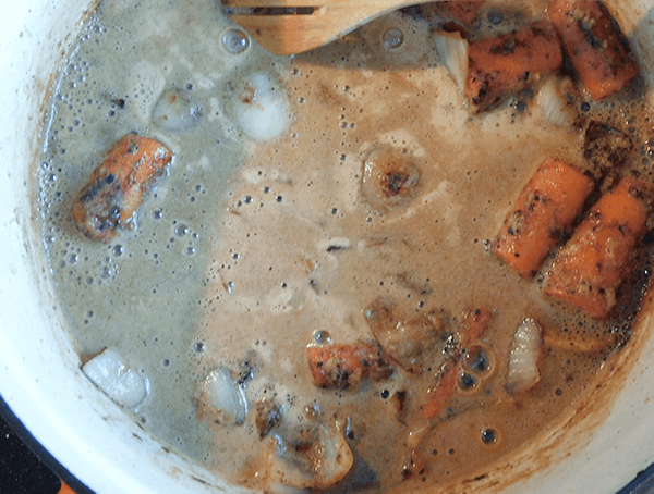 Carrots and onion in dutch oven with brown beer