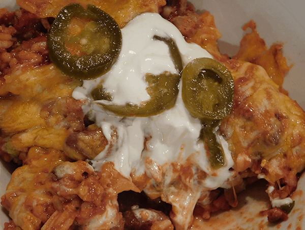 Prepred Tex-Mex sausage skillet with sour cream and jalapenos