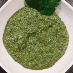 Green Chimichurri Sauce in a white bowl on a black background