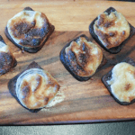 Pumpernickel Onion Toasties ready to serve on a wood board