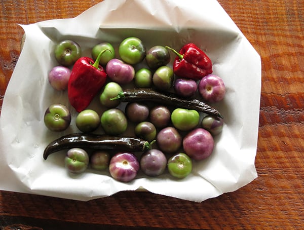 Tomatillos in a bowl with parchment paper