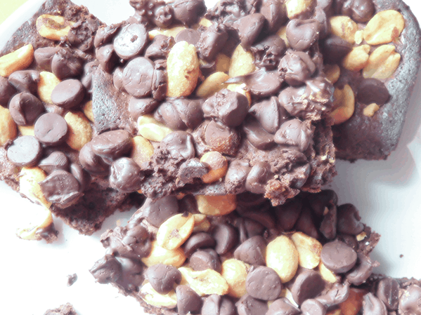 Multiple Brownies on a plate with chocolate chips and peanuts