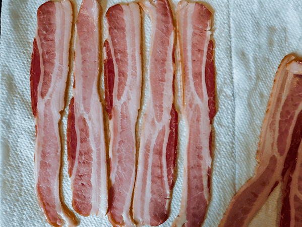 Raw bacon on a white paper towel