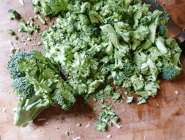 Chopped broccoli on a chopping block