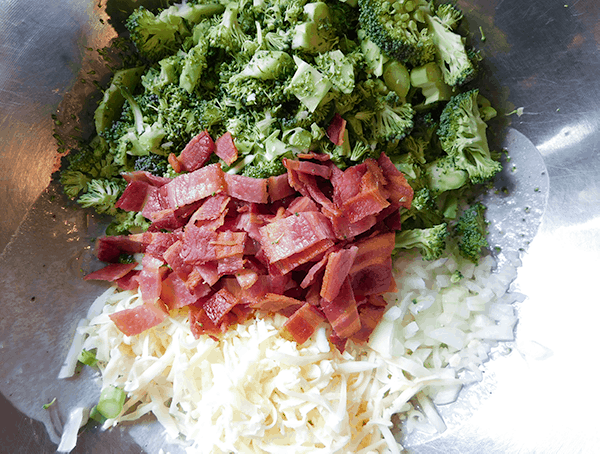 Big mixing bowl with all ingredients for Broccoli Salad