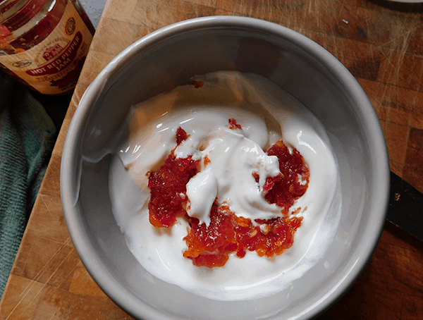 Sour cream and hot pepper jelly in a serving bowl before mixing
