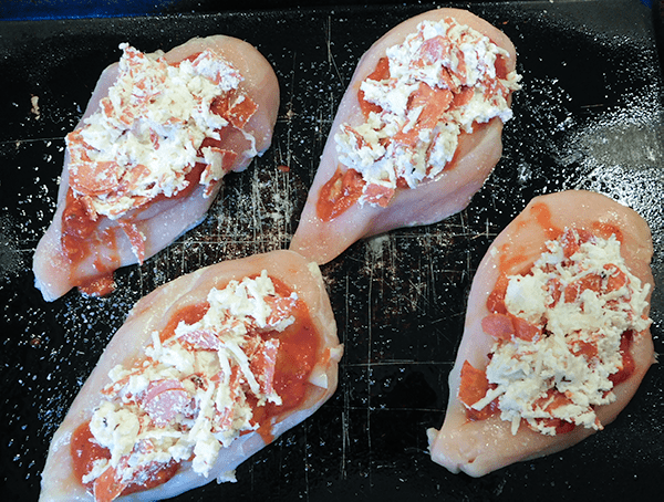 Stuffed Pepperoni Pizza Chicken on baking sheet ready for oven