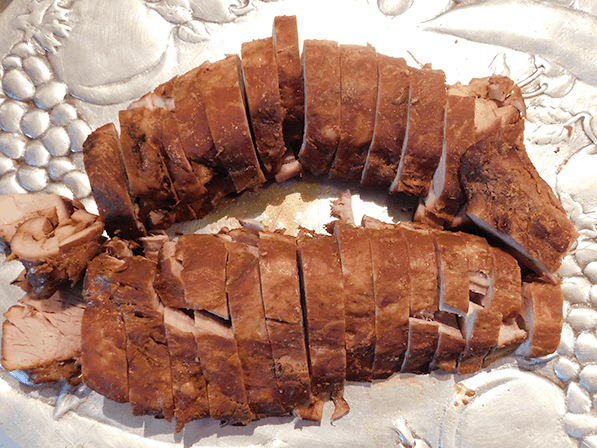 Sliced Asian Pork Tenderloin on a silver platter