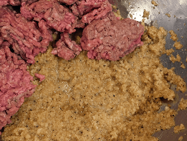 Ground beef and wet bread crumb mix in silver bowl
