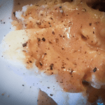 Weeknight Mashed Spuds swimming in brown gravy and pepper
