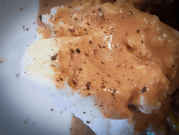Weeknight Mashed Spuds swimming in brown gravy and pepper