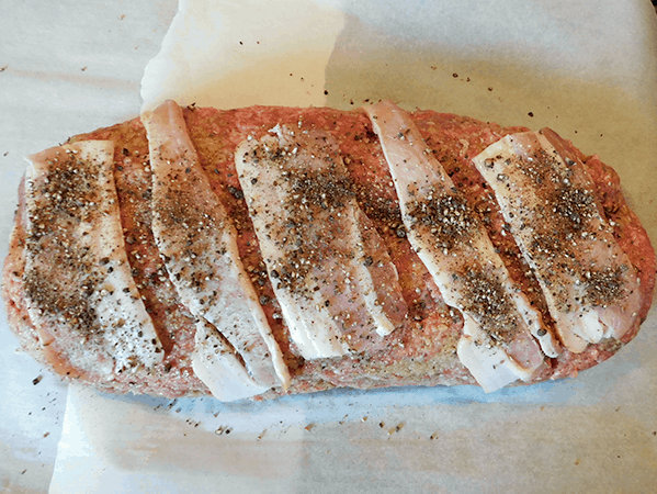 Meatloaf ready for oven with bacon and pepper