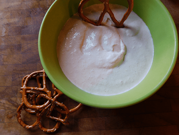 Horseradish Dip in a green bowl with pretzels