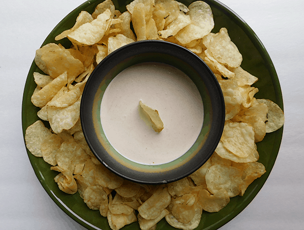 Horseradish Dip in a bowl surrounded by potato chips