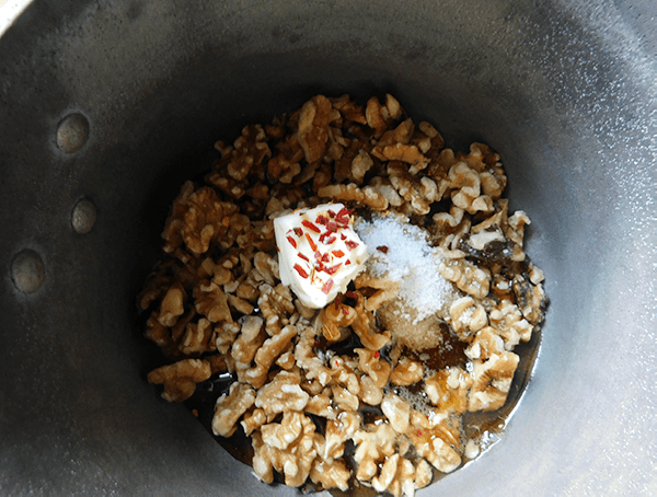 Walnuts. butter and syrup in pan cooking for Maple Walnut Baked Brie