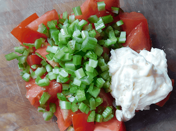 Tomatoes, celery and mayo in a bowl