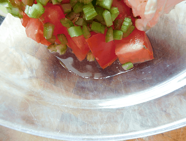 Tomato bowl tilted to show the liquid forming