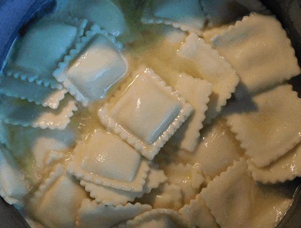 Cooked Ravioli nestling in chicken broth