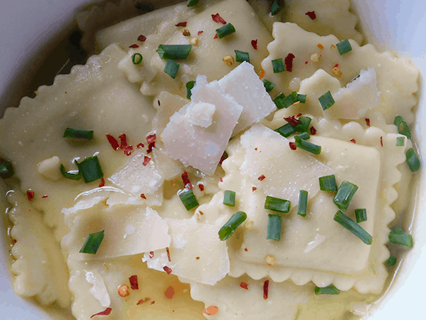 Ravioli in Broth in white bowl