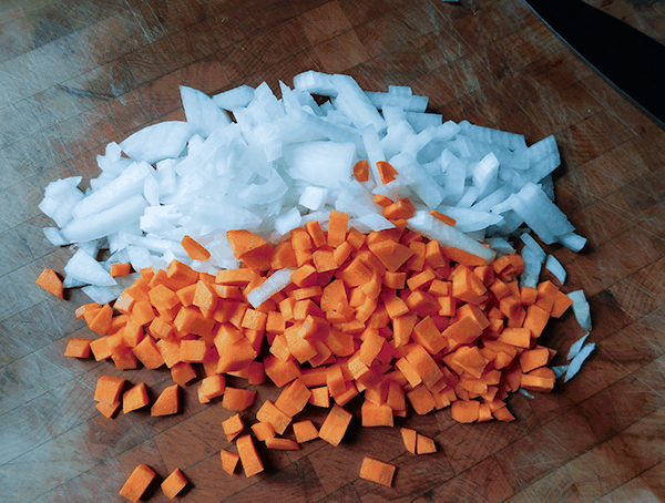 Carrots and Onion chopped on a wooden board