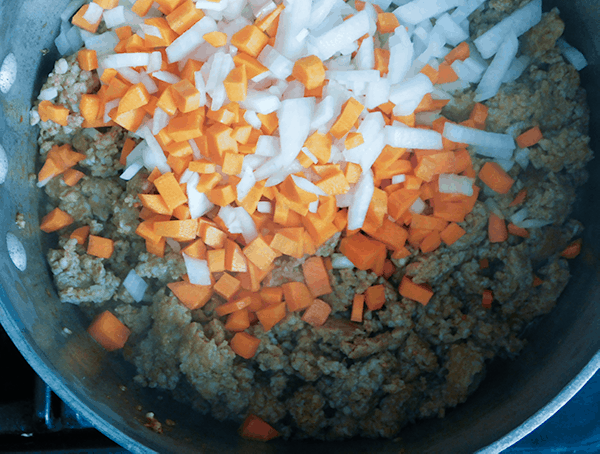 Sausage with carrots and onions cooking for Sausage Ragu