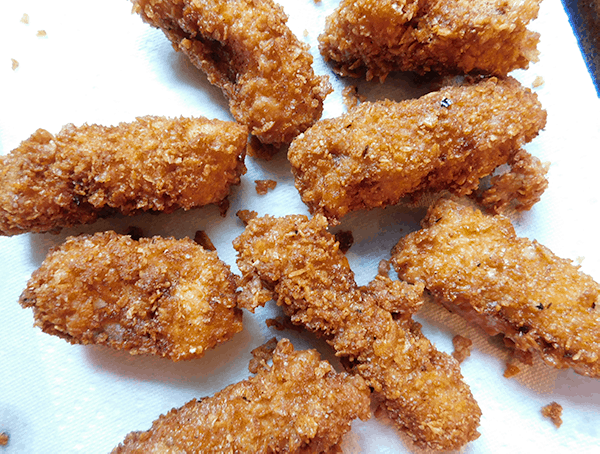 Crispy Fried Fish draining on paper towels